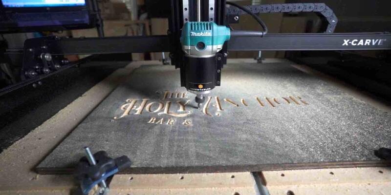X Carve cutting into wood to create a sign