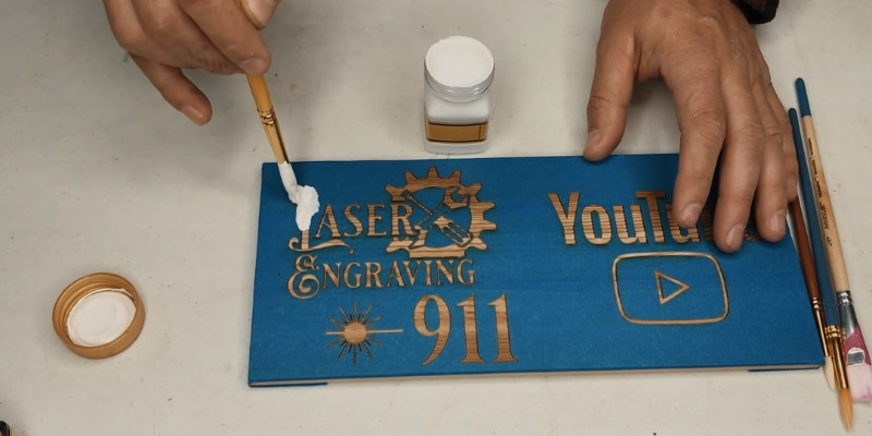 Color filling a wood engraving with paint