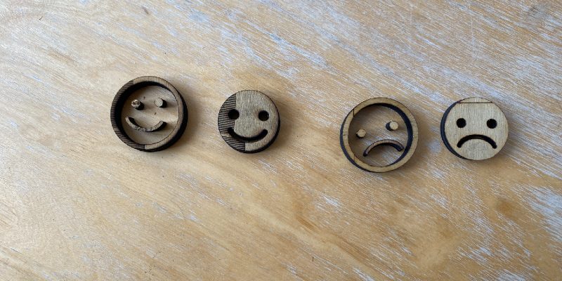 Laser cut wooden smiley faces and sad faces