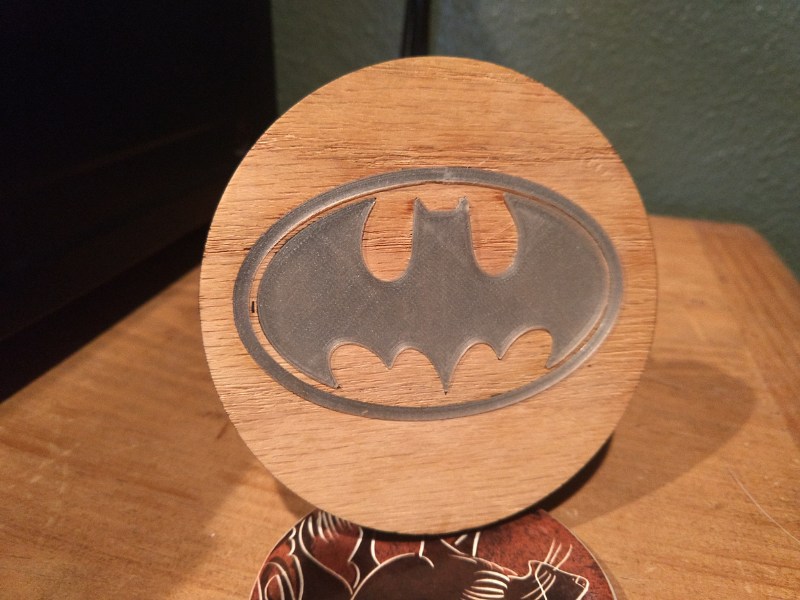 3D printed glow in the dark filament pressed into laser cut batman logo