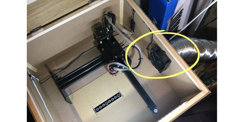 Showing the inside of a DIY enclosure for the Neje Master 2: extractor fan, duct, and air assist pipes