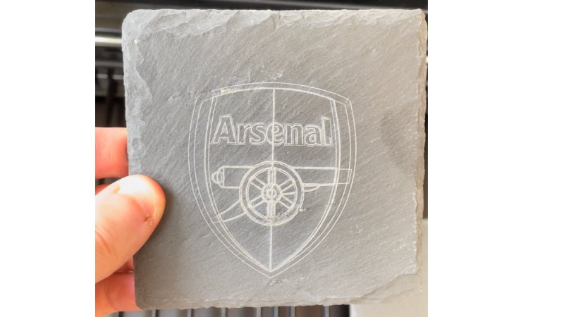 Laser engraving the Arsenal FC logo onto a square rock coaster with the xTool P2