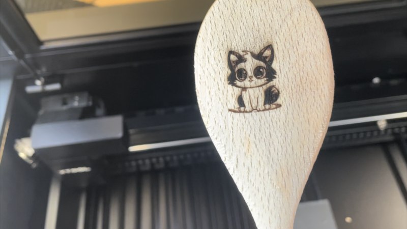 xTool P2 curved surface engraving a wooden spoon