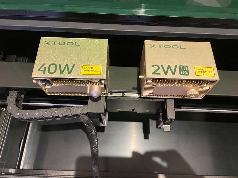 Both the 40W and 2W laser heads for the xTool S1 next to each other 